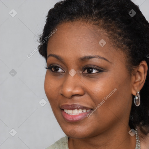 Joyful black young-adult female with medium  brown hair and brown eyes