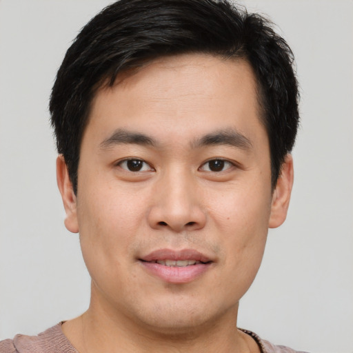 Joyful asian young-adult male with short  brown hair and brown eyes