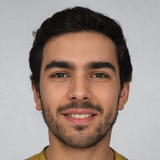 Joyful white young-adult male with short  brown hair and brown eyes