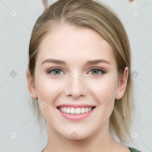 Joyful white young-adult female with medium  brown hair and green eyes