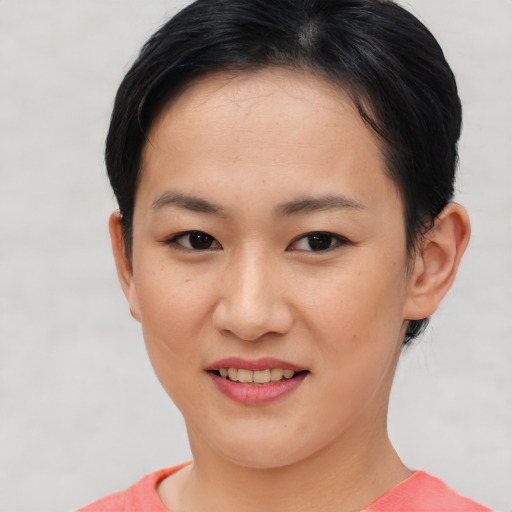 Joyful asian young-adult female with short  brown hair and brown eyes