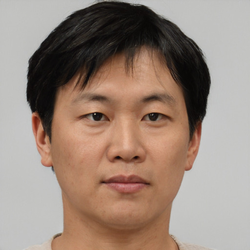 Neutral asian adult male with short  brown hair and brown eyes