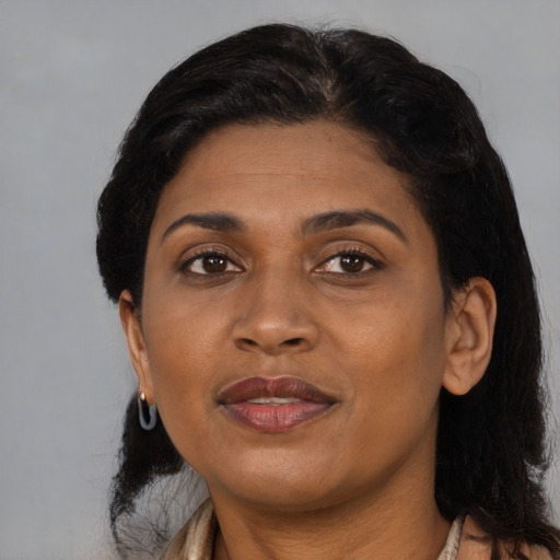 Joyful black adult female with medium  black hair and brown eyes
