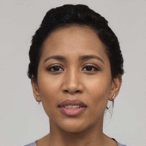 Joyful latino young-adult female with short  black hair and brown eyes
