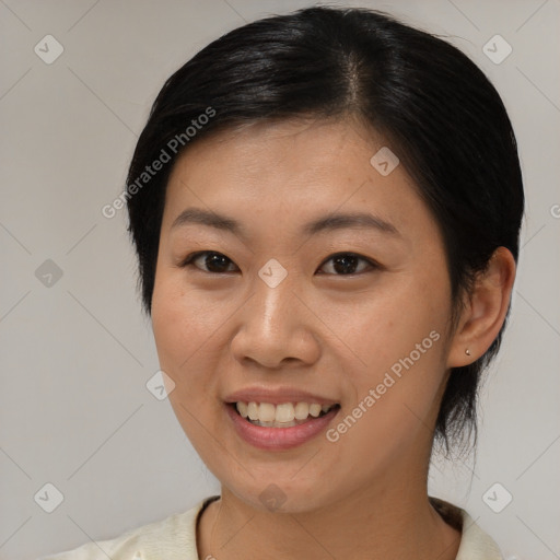 Joyful asian young-adult female with medium  black hair and brown eyes