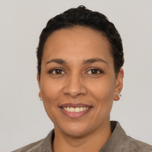 Joyful latino adult female with short  black hair and brown eyes