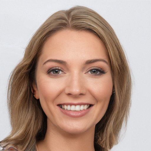 Joyful white young-adult female with long  brown hair and brown eyes