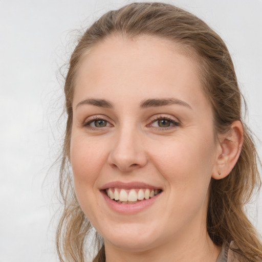 Joyful white young-adult female with long  brown hair and grey eyes