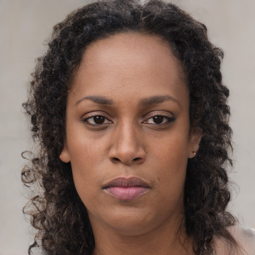 Neutral black young-adult female with long  brown hair and brown eyes