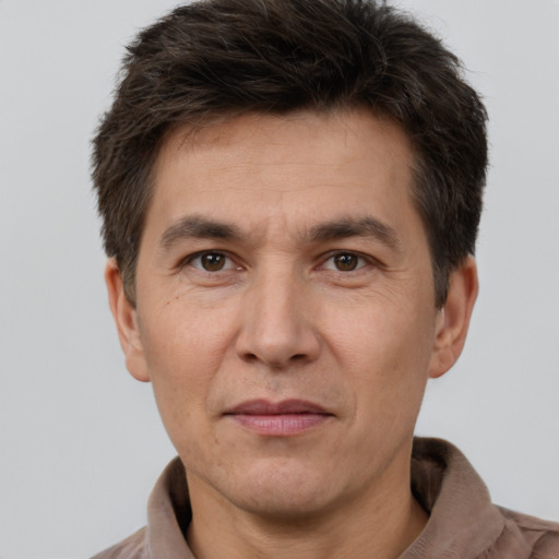 Joyful white adult male with short  brown hair and brown eyes