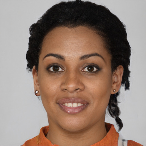 Joyful black young-adult female with short  black hair and brown eyes