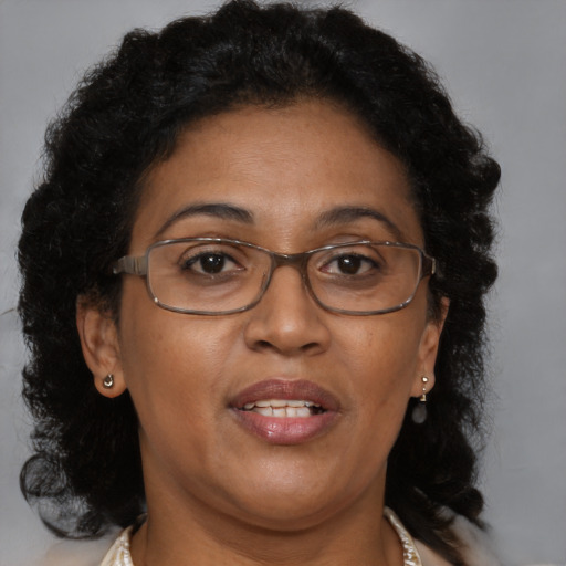 Joyful black adult female with medium  brown hair and brown eyes