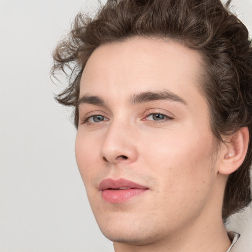 Joyful white young-adult male with medium  brown hair and grey eyes