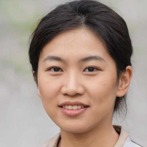 Joyful asian young-adult female with medium  brown hair and brown eyes