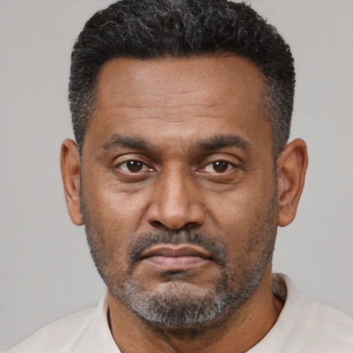 Neutral latino adult male with short  black hair and brown eyes