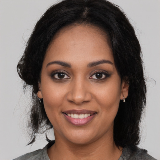 Joyful latino young-adult female with medium  black hair and brown eyes