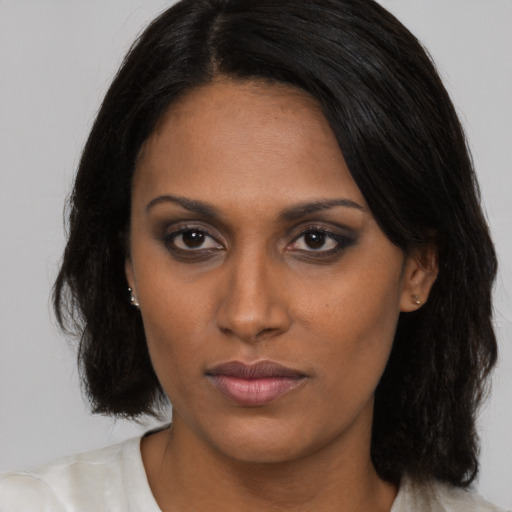 Neutral black young-adult female with long  brown hair and brown eyes