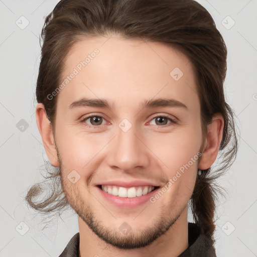 Joyful white young-adult male with medium  brown hair and brown eyes