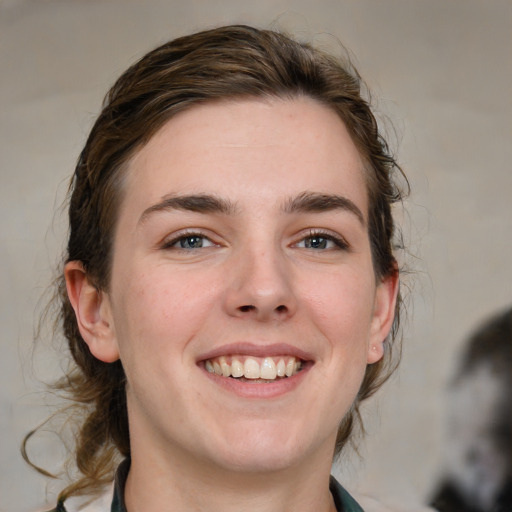 Joyful white young-adult female with medium  brown hair and blue eyes