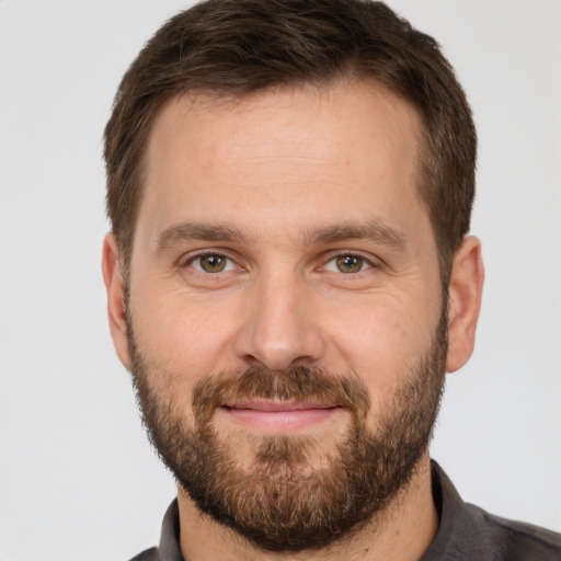 Joyful white adult male with short  brown hair and brown eyes