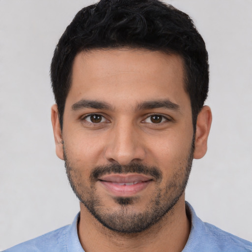 Joyful white young-adult male with short  black hair and brown eyes
