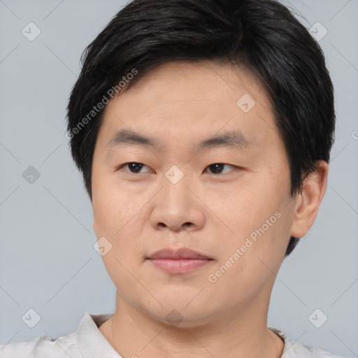 Joyful asian young-adult male with short  black hair and brown eyes