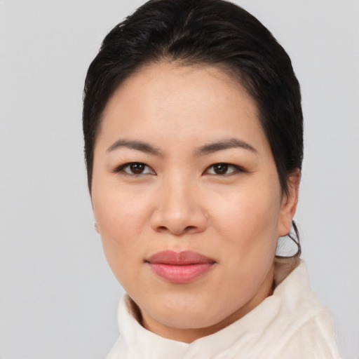 Joyful asian young-adult female with short  brown hair and brown eyes