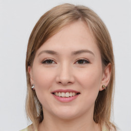 Joyful white young-adult female with long  brown hair and grey eyes