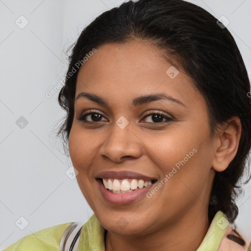 Joyful latino young-adult female with medium  brown hair and brown eyes