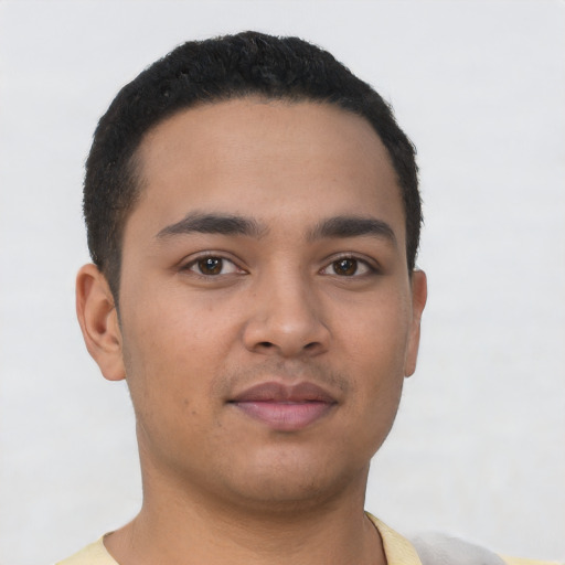 Joyful latino young-adult male with short  black hair and brown eyes