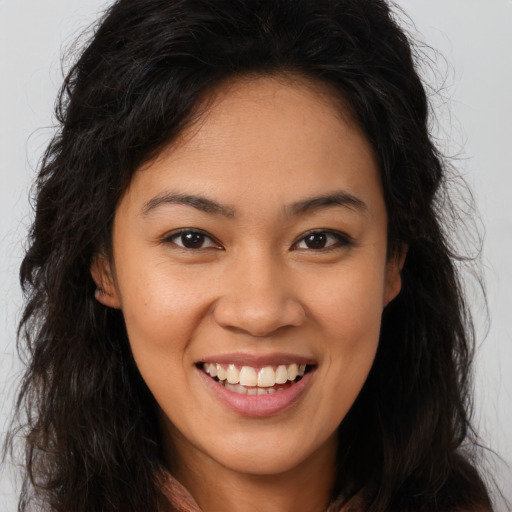 Joyful white young-adult female with long  brown hair and brown eyes