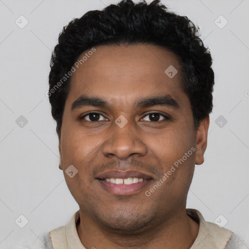 Joyful black young-adult male with short  black hair and brown eyes
