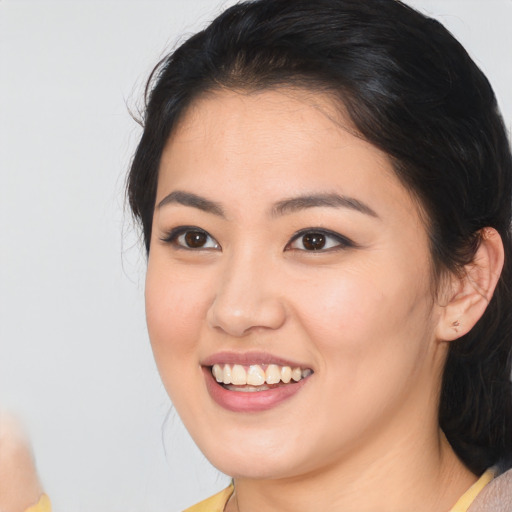 Joyful white young-adult female with medium  black hair and brown eyes