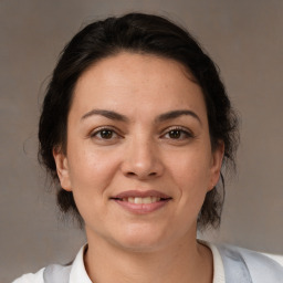 Joyful white adult female with medium  brown hair and brown eyes