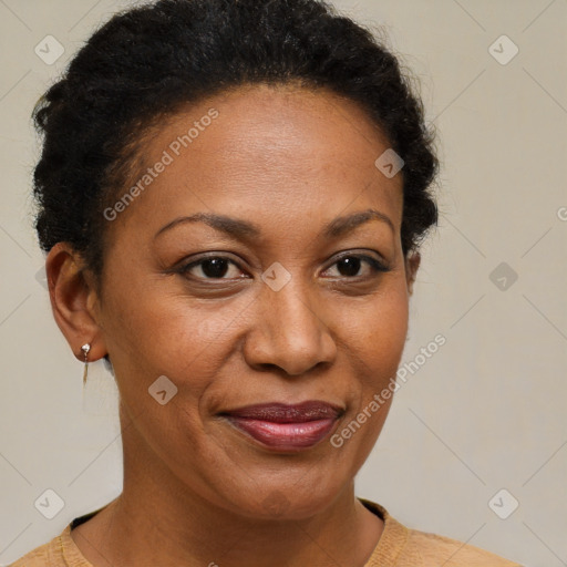 Joyful black adult female with short  brown hair and brown eyes