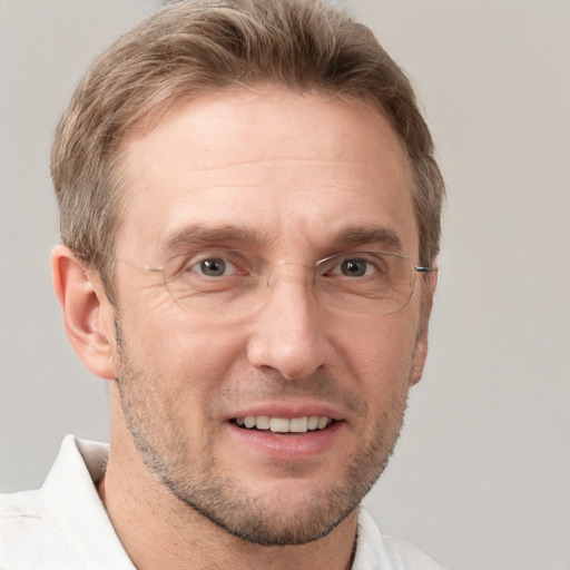 Joyful white adult male with short  brown hair and grey eyes