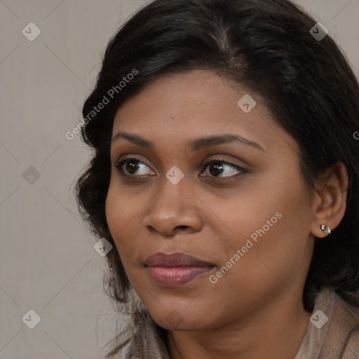 Joyful black young-adult female with long  brown hair and brown eyes