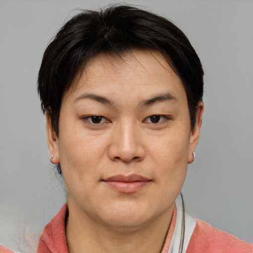 Joyful asian adult female with short  brown hair and brown eyes