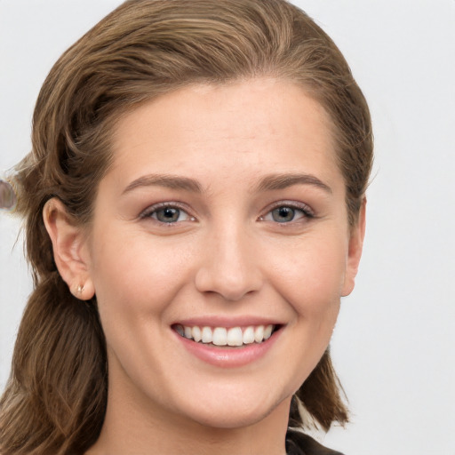 Joyful white young-adult female with long  brown hair and grey eyes