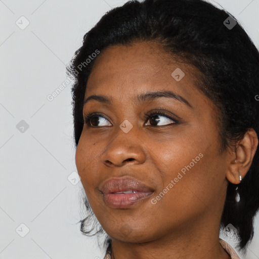 Joyful black young-adult female with medium  black hair and brown eyes