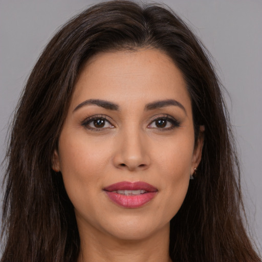 Joyful white young-adult female with long  brown hair and brown eyes