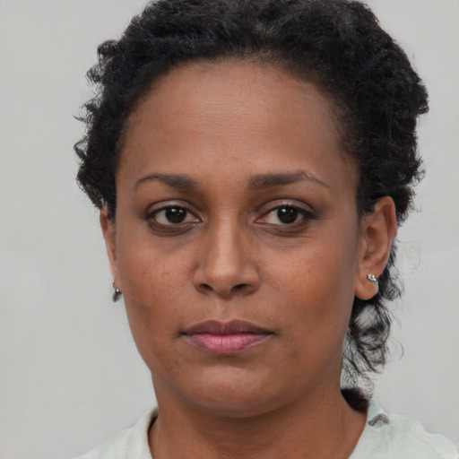 Neutral black young-adult female with short  brown hair and brown eyes