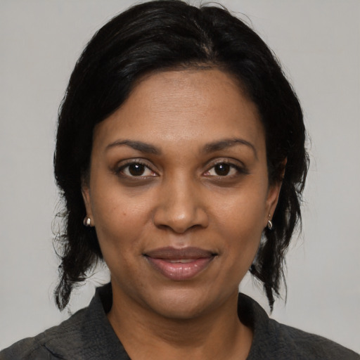 Joyful black adult female with medium  black hair and brown eyes