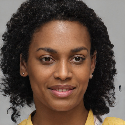 Joyful black young-adult female with medium  brown hair and brown eyes