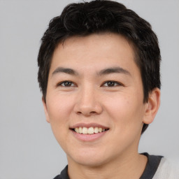 Joyful asian young-adult male with short  brown hair and brown eyes