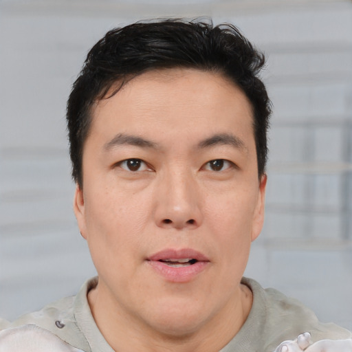 Neutral asian young-adult male with short  brown hair and brown eyes