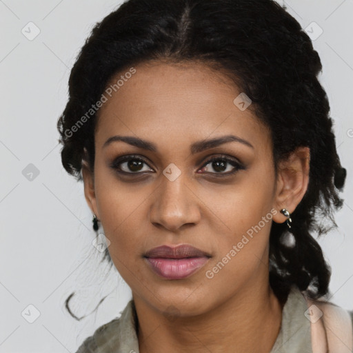 Joyful black young-adult female with long  black hair and brown eyes