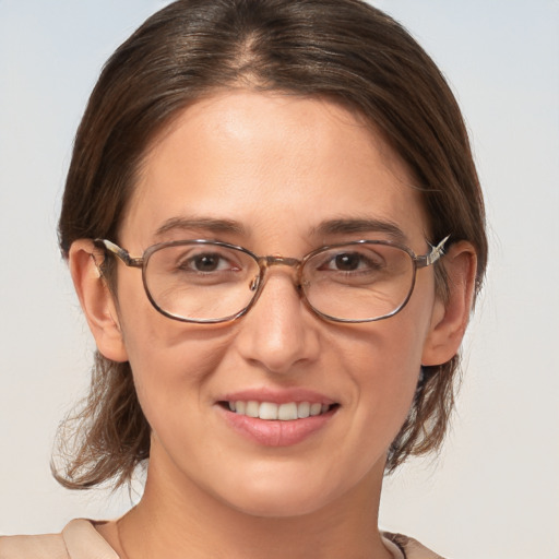 Joyful white adult female with medium  brown hair and brown eyes