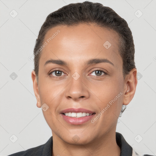 Joyful white young-adult female with short  brown hair and brown eyes