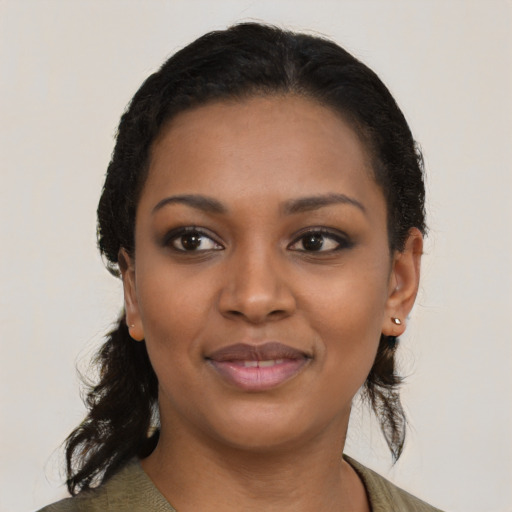 Joyful black young-adult female with medium  black hair and brown eyes